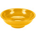 A yellow Fiesta pedestal serving bowl on a white background.