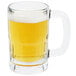 A Libbey glass beer mug filled with beer on a white background.
