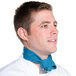A man wearing a teal Intedge chef neckerchief around his neck.