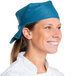 A woman wearing a teal chef bandana.