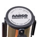 A close up of a white and black Aarco label on a brass crowd control stanchion.