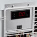 The thermostat control panel on a white Avantco countertop display freezer with red digital numbers.