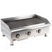 A stainless steel APW Wyott charbroiler with three radiant burners and knobs.