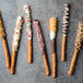 A Snyder's of Hanover chocolate covered pretzel rod with orange and brown sprinkles.