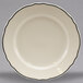 A white Homer Laughlin china plate with black trim on the scalloped edges.