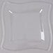 A clear square plate with a curved edge.