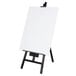 A white board on a black Choice wood easel stand.