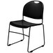 A National Public Seating black plastic stackable chair with a black metal frame.