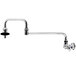 A T&S chrome wall mounted pot filler faucet with a double-jointed nozzle and lever handle.
