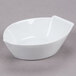 A CAC white porcelain boat bowl with a handle.