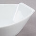 A CAC Super White porcelain boat bowl on a gray surface.