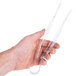 A hand holding Thunder Group clear polycarbonate flat grip tongs.