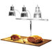 A Hanson Heat Lamps triple bulb carving station with meat on a table.