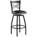 A Lancaster Table & Seating black cross back swivel bar stool with a black padded seat.