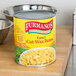 A Furmano's #10 can of wax beans on a table in a professional kitchen.