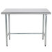 An Advance Tabco stainless steel work table with metal legs.