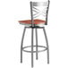 A Lancaster Table & Seating bar stool with a cherry wood seat and metal frame.