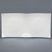 A white square CAC China divided tasting plate with a black border.