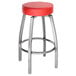 A Lancaster Table & Seating clear coat metal bar stool with a red vinyl swivel seat.