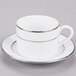 A white porcelain cup and saucer with silver stripes.