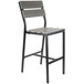 A BFM Seating black aluminum outdoor restaurant bar stool with a gray synthetic teak back and seat.