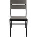 A BFM Seating stackable outdoor chair with a black frame and gray synthetic teak back and seat.