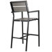 A black aluminum BFM Seating outdoor bar stool with a gray synthetic teak back and seat.