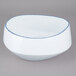 A white porcelain bowl with a blue rim.