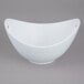 A white porcelain bowl with cut-out handles.