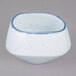 A white porcelain bowl with blue speckles.