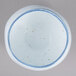 A white bowl with blue specks on the rim.