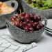 A close-up of grapes in a 10 Strawberry Street granite porcelain bowl with cut-out handles.
