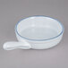A white bowl with a handle and a blue rim.