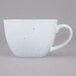 A white 10 Strawberry Street Arctic Blue porcelain cup with a speckled design on it and a handle.
