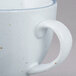 A white porcelain cup with a handle.