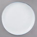 A white porcelain dinner plate with a blue rim.