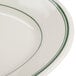 An ivory oval china platter with a green band on the rim.