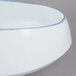 A white porcelain pasta bowl with a blue rim.
