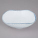 A white bowl with a blue speckled rim.
