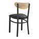 A black Lancaster Table & Seating chair with a black vinyl seat and driftwood back.