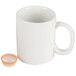 A white mug with a small orange cup.