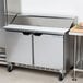 A Beverage-Air stainless steel 2 door refrigerated prep table on a white counter.
