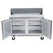A Beverage-Air stainless steel refrigerated sandwich prep table with two open doors.
