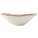 A white Tuxton china bowl with brown speckles and gold trim.