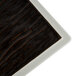 A close up of a Tuxton TuxTrendz Kona Lava and Bright White square plate with black and white surfaces.