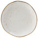 A white Tuxton china plate with brown specks.
