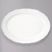 A white Tuxton oval platter with a scalloped edge.