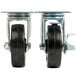A pair of Avantco plate casters with black rubber wheels and metal mounting hardware.