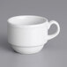 A white Tuxton espresso cup with a scalloped edge and handle.