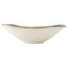 A white Tuxton china bowl with a blue rim.